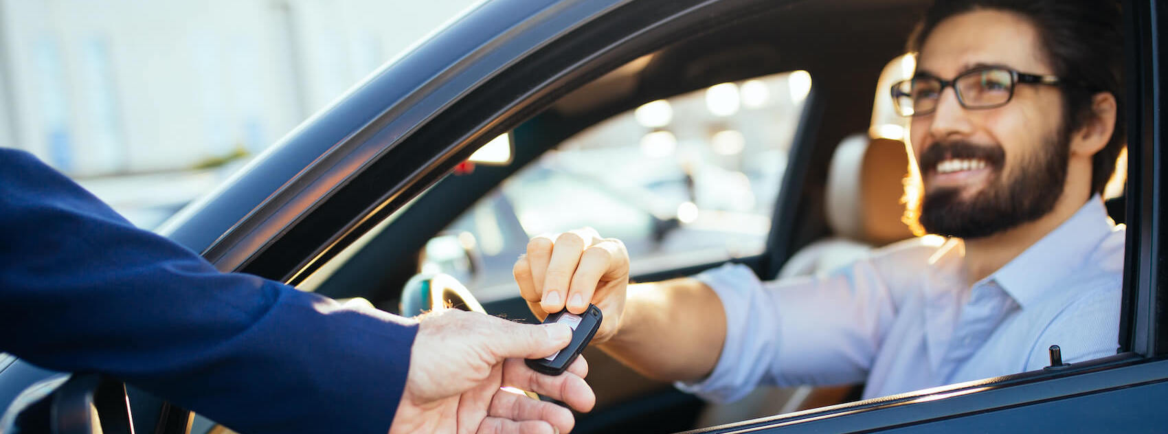 Man being handed car keys